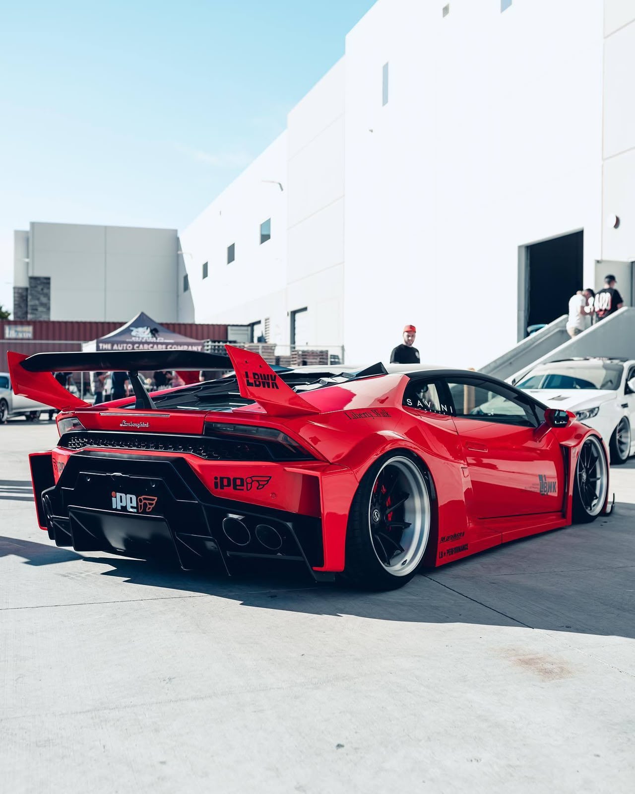 Red widebody Lamborghini at an outdoor show