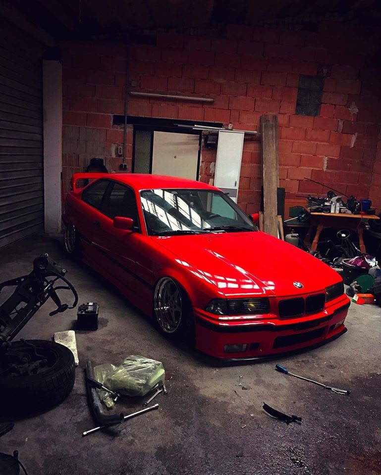 Red lowered BMW inside a garage